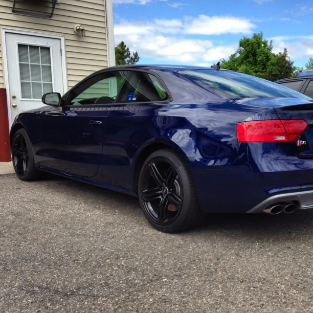 Blue Audi S5 with black wheels parked in a driveway